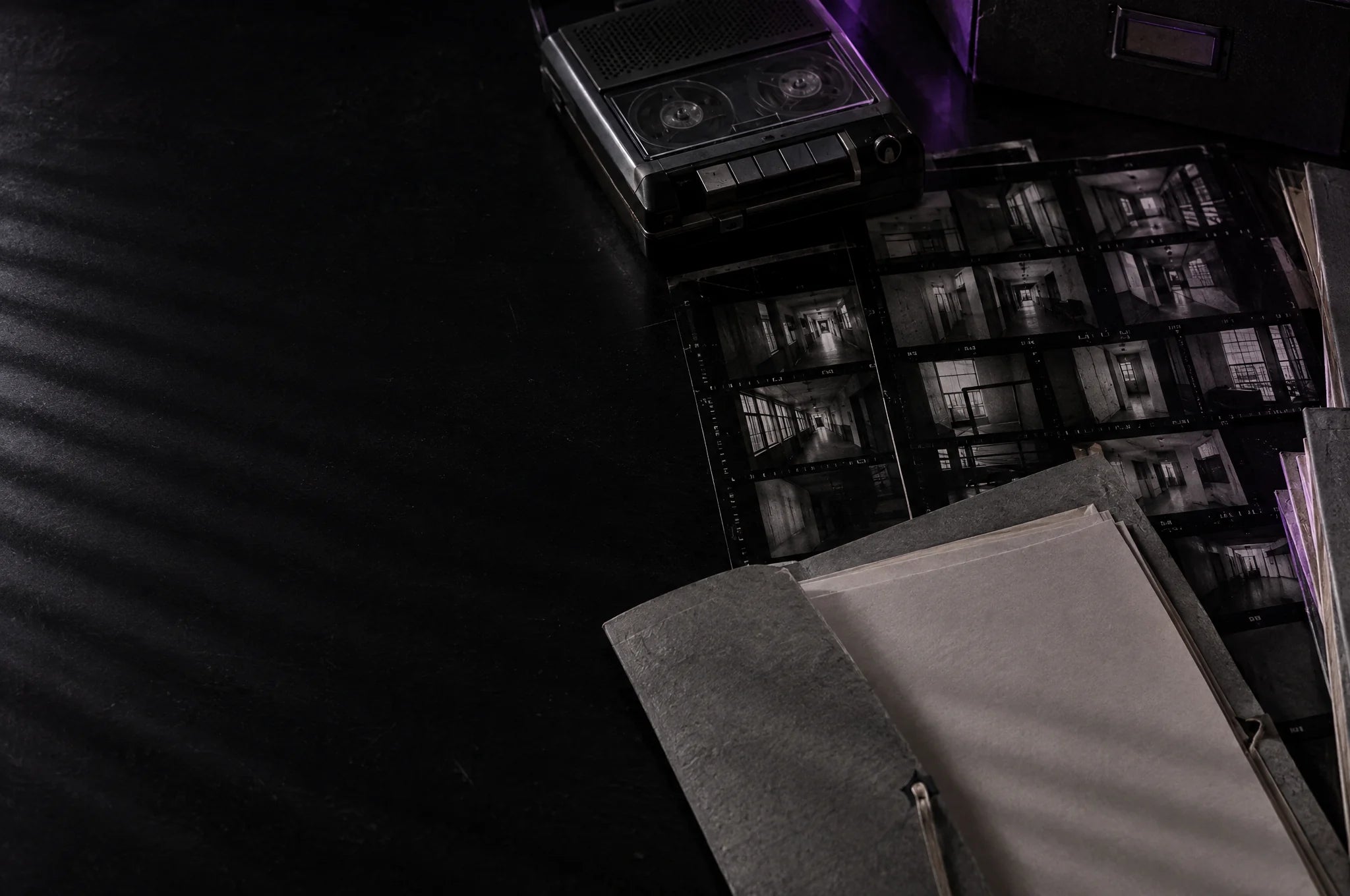 Contact sheets and a document folder on a Side Quests planning desk